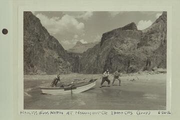 Moulty Fulmer, Guy Taylor and Norm Day drag the "Gem" onto the beach at foot of Monument Creek Rapid
