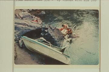 Salvage of July 16,1966 at head of Gneiss Canyon Rapid. The hull is foreground the transom with engine beyond