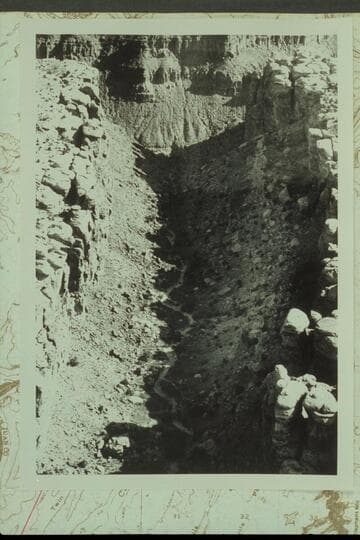 Northerly down the graben that drains into Red Lake Canyon about a mile from the Colorado River. The small pinnacle at the right side of the mouth shows in Reilly photo #3 internegative 584 CTCN 213.3 and in Marston photo 5610 CTCN 213.4