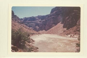 Down from approximately Mile 202.75 at head of Rapid No. 21, which heads at Mile 202.8 and drops 10 ft. in .25 miles. The beach at right is below the mouth of Teapot Canyon. Mile 202.7. See Nims photos 80 and 83 and Hyde photo of 1928, Nov. 01