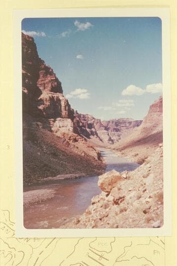 Up Cataract Canyon from Mile 203. The island at lower left is covered in high water. Rapid No. 19 is in the middle distance. Last week of June, 1960