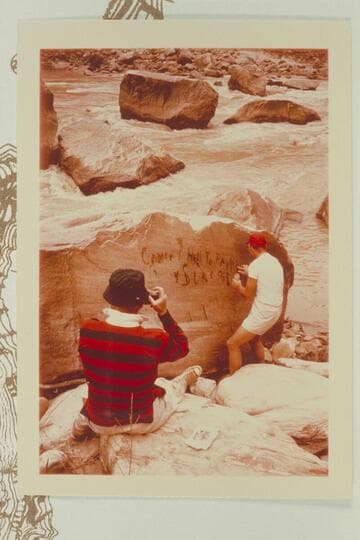 Dock photographs Jorgen Visbak wetting the Best Expedition inscription reading. "Camp No. 7. Hell To Pay. No. 1 is Sunk and Down" cut in the rock by McDonald