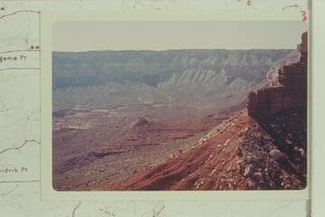Across the toe of Stanton Point into Fossil Bay. The route off the rim into Fossil Bay is over the talus on the right of center where the Coconino is covered