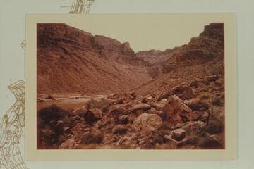 Up river from left bank at Mile 205.2. The boulder at the left margin is at the mouth of Wide Valley at Mile 205.3 and is in Nims photo 76
