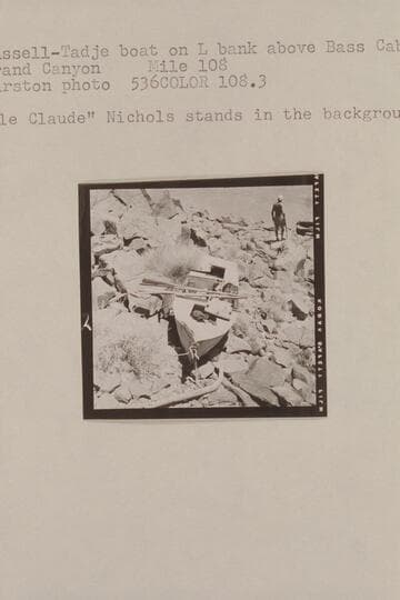 Russell-Tadje boat on left bank above Bass Cable. Grand Canyon, Mile 108. "Ole Claude" Nichols stands in the background