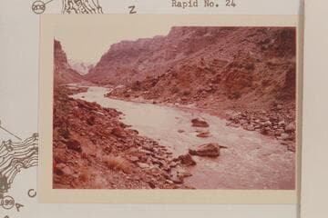 Up river to the large boulders at the head of Rapid No. 22. At the low water shown the rapid is in two sections. Visbak capsized his Sportyak at the large boulder near the right bank