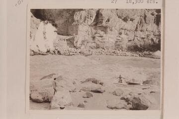 Lining the Nevills skiffs at Lava Falls. Nevills is in the boat. Garth Marston is handling the stern line and Randall Henderson watches
