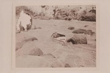 Nevills scrambles into the boat being lined at Lava Falls. Garth Marston is handling the stern line at the left