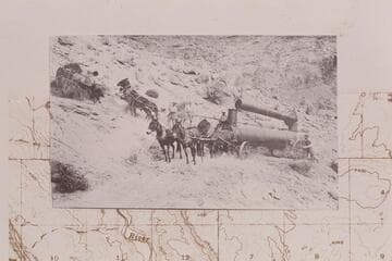 Boiler on the north side of Lees Ferry. Teams on hillside above the road were hooked to rear of boiler as real wheels were tracking off the road. Copy of print in Waller collection