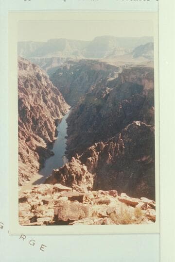 Upriver from directly above Grapevine Rapid. Route of Spur Trail appears. The sun lights the saddle