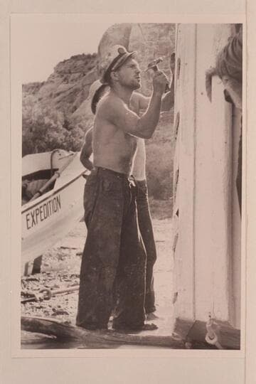 Buzz Holmstrom helping with the repair of one of the Nevills skiffs at Pats Hole. Note the short hold on the hammer