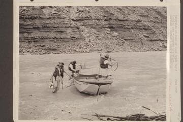 "Esmeralda" at foot of Soap Creek Rapid. Caching gas, pumping the bilge. Marston; Taylor; Edward Hudson. Stage 65,000 -+ cfs