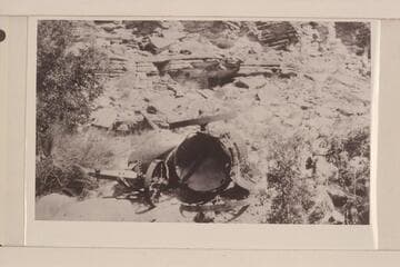 A wrecked boiler at the mouth of Slickhorn Canyon. Boiler was being lowered to bottom of San Juan Canyon and when near bottom broke loose and rolled to bottom