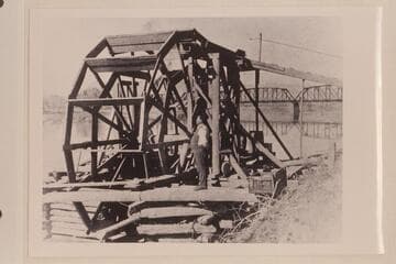 Water wheel just below railroad bridge. Green River at Green River, Utah