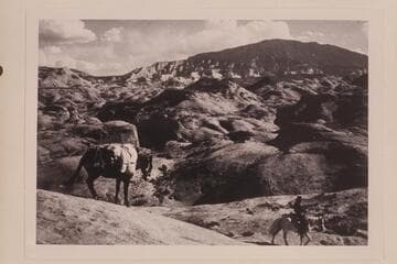 Cha Butte upper left. Navajo Mountain from trail down from mesa west of Nasja Creek into camp near the joint. Tobe Owl rides ahead of the pack. The sloping mesa is 4903. d