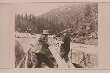 The sweep-scow threads among the rocks of the Salmon River, Idaho. Carl Kriley and Don Smith at the sweeps