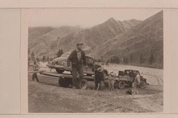 The heavy truck and trailer designed for hauling the scow back to Salmon City also freights the car of passengers around to the end of the trip. Don Smith is foreground