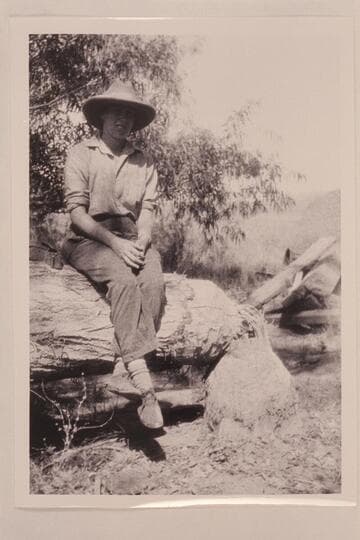 Sarah Fraser. Glen Canyon. Traverse from Hite to Lees Ferry. Sitting on a beaver-cut tree
