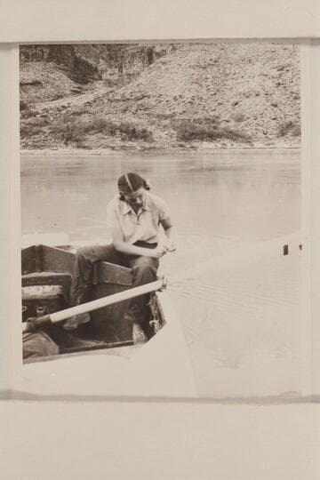 Anne Desloge cleaning fish. The boat is moored at the beach on right bank below Tapeats Creek