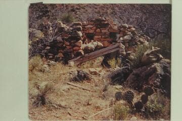 Boucher's rock cabin at junction of Boucher Creek and Trail Gulch. Two National Park Service sleeping bags