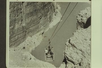 The skip on the lower cable at the upper Marble Canyon damsite. The near boat is the "Esmeralda II." The boat next to it is the 19-ft. Chris-Craft "Hudson."