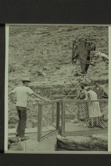 Marion Hudson prepares to step out of the skip while Margaret Marston picks up her bags. The ledge camp of the USBR