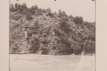 Head of Ashley Falls in Red Canyon. Nevills and Frost are in the boat which has been rowed across to the head of the rapid in preparation for lining