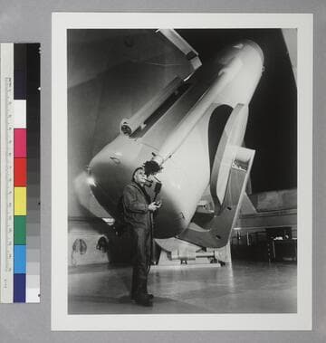 Edwin Powell Hubble looking in the Schmidt telescope