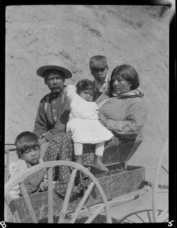 Southwest Indian family riding in wagon