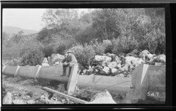 A man sitting on the side of the conduit