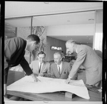 Men reviewing plans for an 18 story apartment building