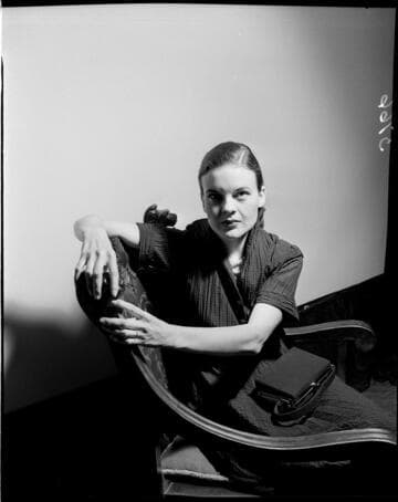 Lady turned in chair against white backdrop