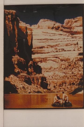 Bus Hatch running a motor on a 10-man inflated boat. Four miles below Mantle's Ranch on the Yampa River