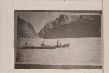 Al Jagerson at wheel of tunnel boat built in fall of 1921. Below Bonelli Landing. Crew probably John Shull and Murl Emory