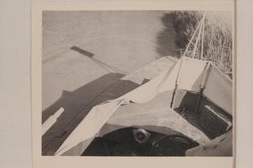 The battered shield of the "Esmeralda II" after running Chuar Rapid. Foot of the Tanner Trail. The shield was put on over Hudson's protest, and he made the standards of pipe