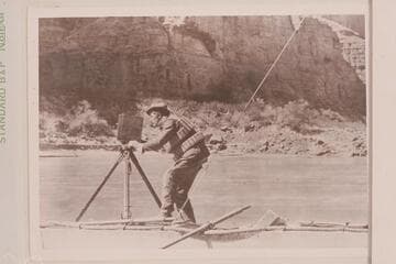 August J. Tadje with M camera on one of our boats floating downstream. Tadje is standing on the "Titanic."